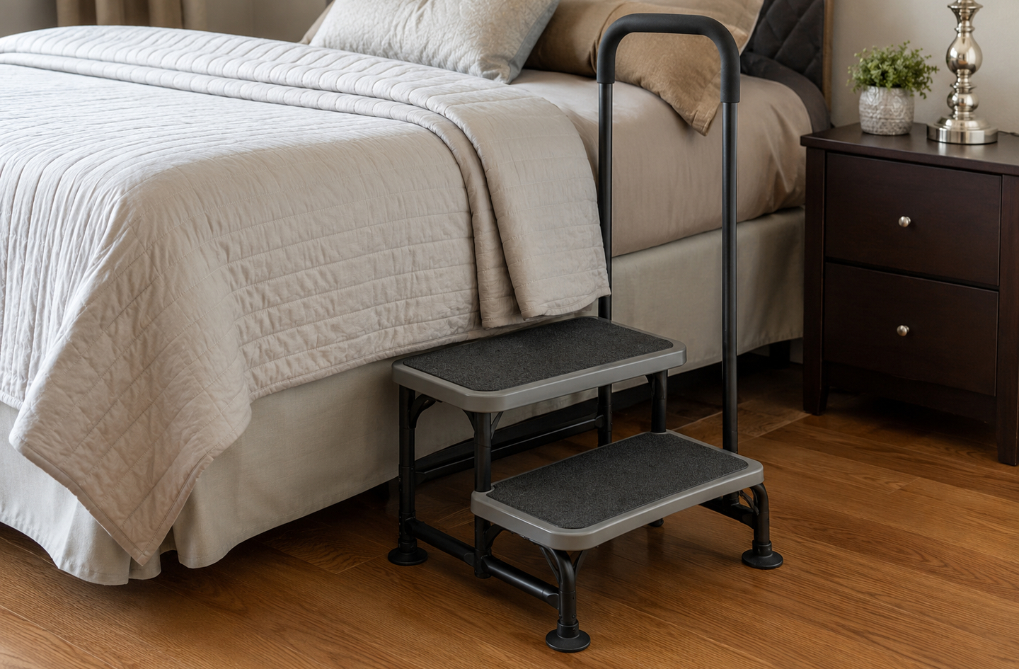 Two-tier bedroom safety step stool with a support handle and textured treads beside a bed